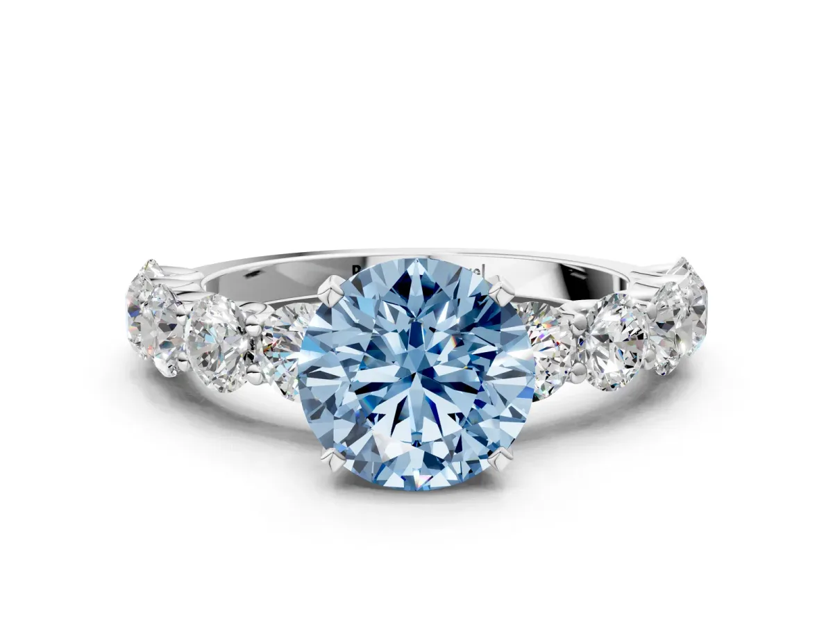 Fancy Blue Round Cut Diamond Prong Setting with Side Stones on a Pave Band Silver