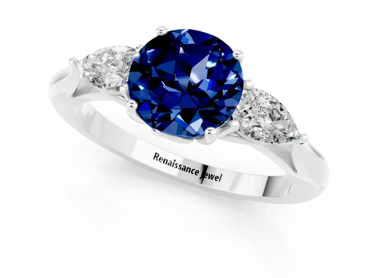 Three-Stone Round Cut Blue Sapphire Ring with Pear Side Stones in Four-Prong Setting Platinum