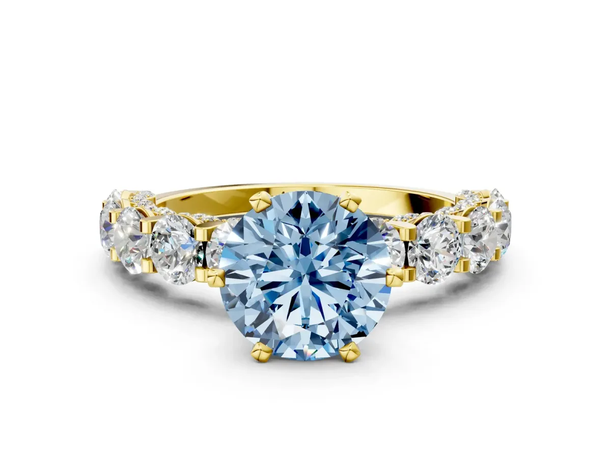 Fancy Blue Round Cut Diamond Side Stone Engagement Ring with Four-Prong Setting Yellow gold