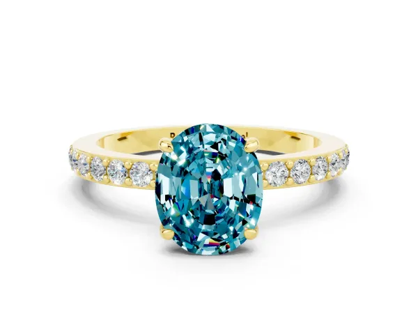 Oval Cut Blue Topaz Solitaire Engagement Ring with Pavé Band and Four-Prong Setting Yellow gold