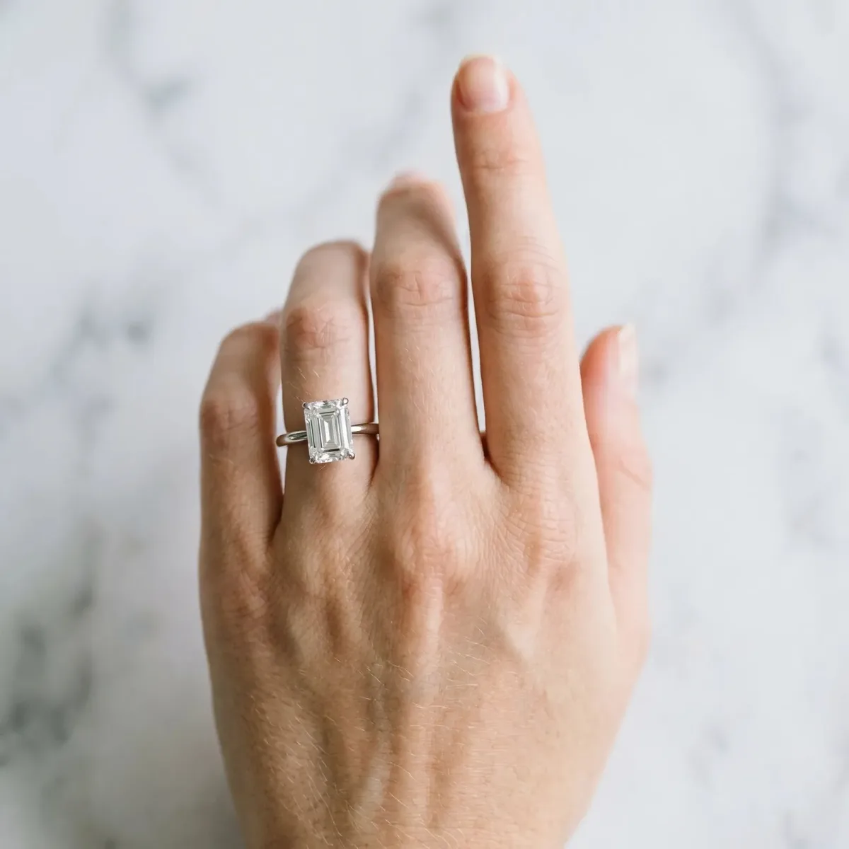 Emerald Cut Diamond Solitaire Engagement Ring with Classic Band and Four-Prong Setting Silver