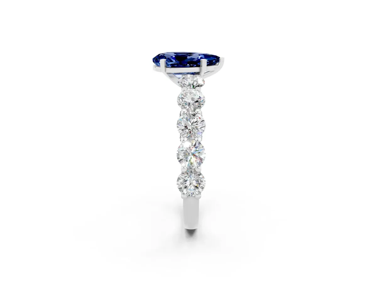 Pear Cut Blue Sapphire Prong Setting with Side Stones on a Pave Band Silver
