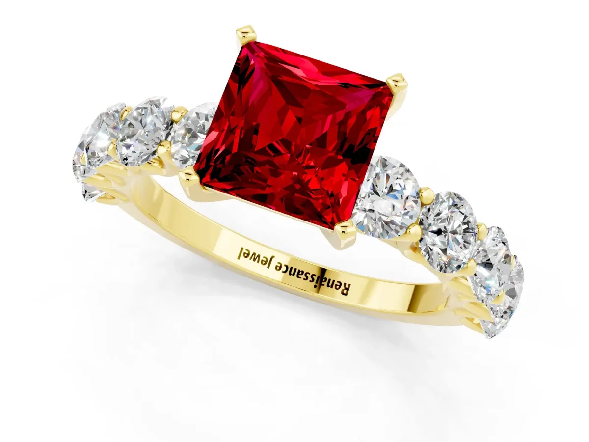 Princess Cut Ruby Prong Setting with Side Stones on a Pave Band Yellow gold