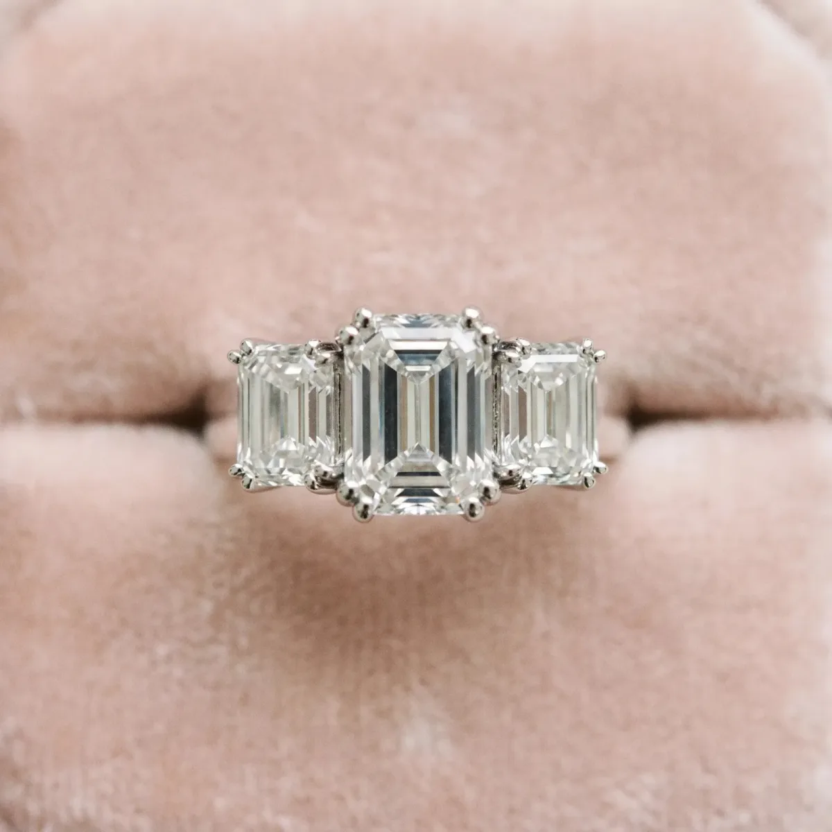 Three-Stone Oval Cut Cut Diamond Ring with Channel Set Band and Four-Prong Setting Silver