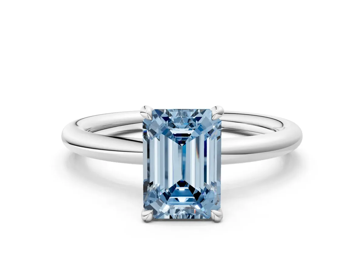 Fancy Blue Emerald Cut Diamond Solitaire Ring with Thin Band and Four-Prong Setting Platinum