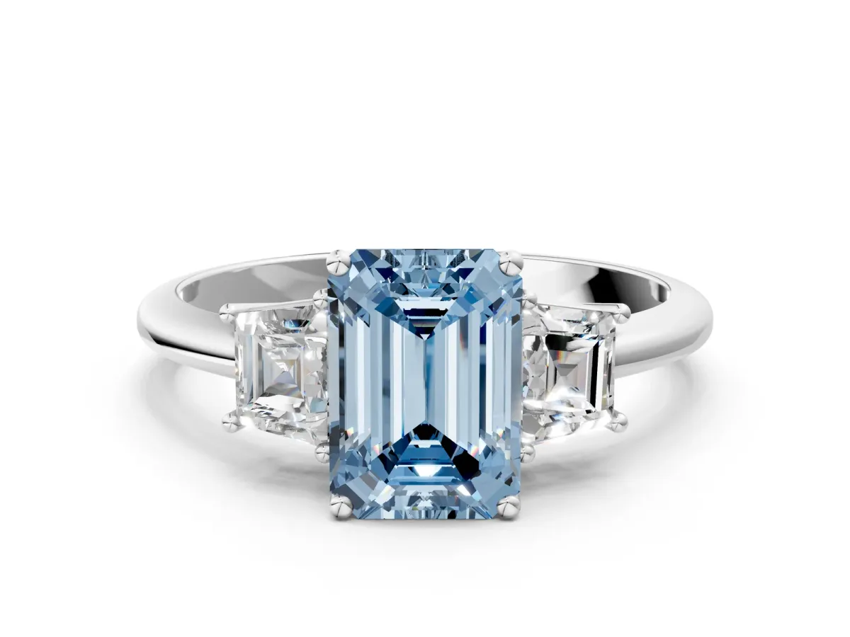 Fancy Blue Emerald Cut Diamond Three-Stone Ring with Trapezoid Side Stones and Prong Setting Silver