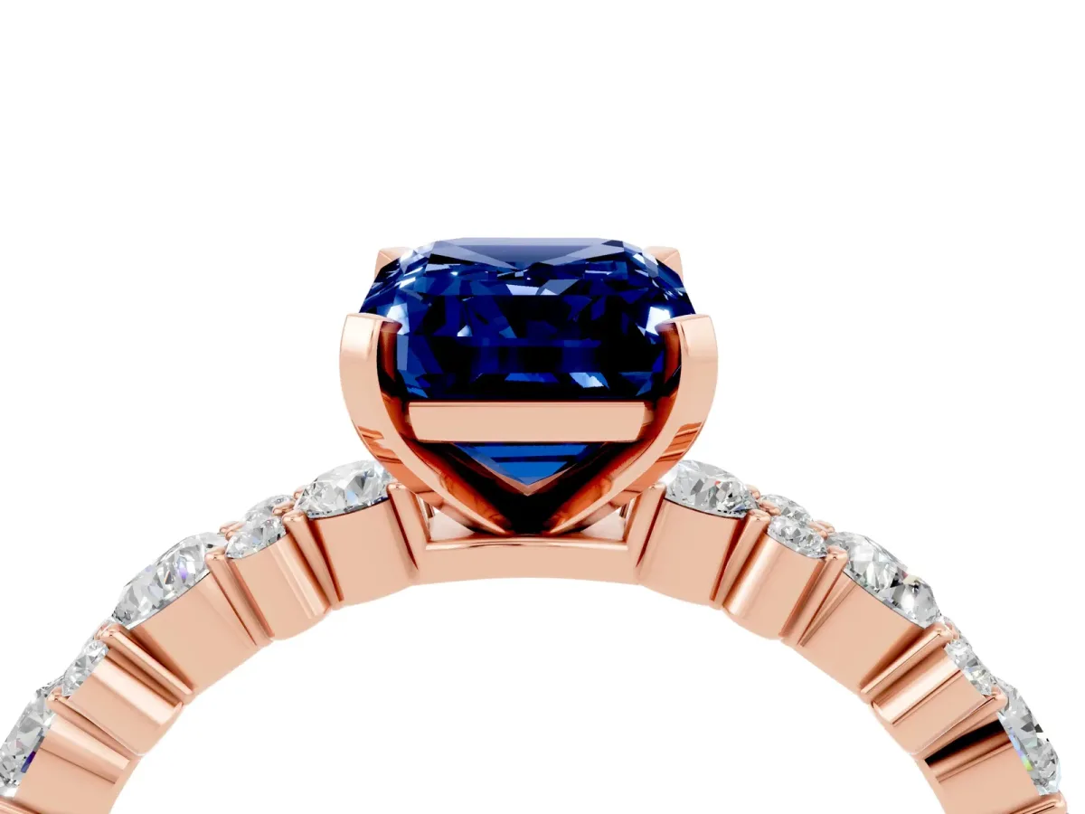 Emerald Cut Blue Sapphire Side Stone Solitaire Ring with Round and Four-Prong Setting Rose gold
