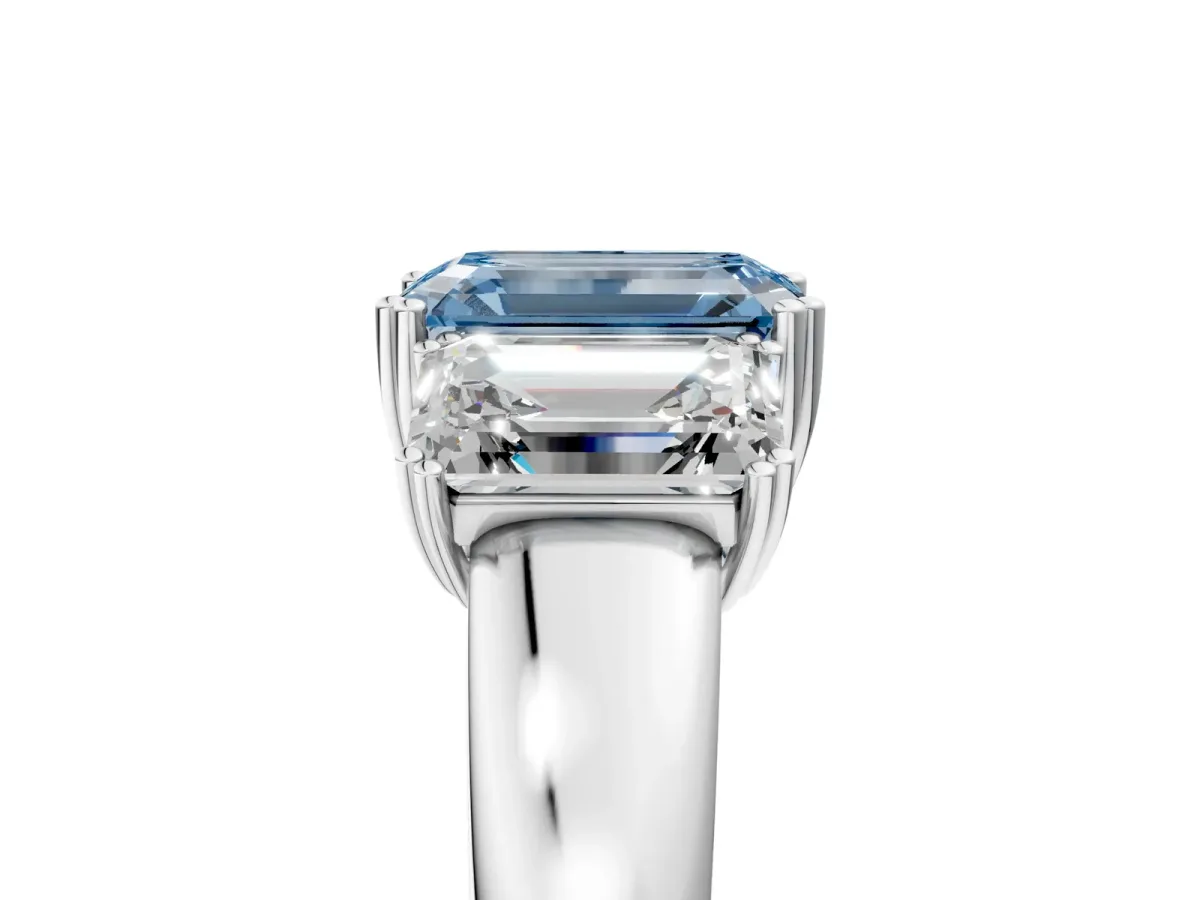Fancy Blue Three-Stone Emerald Cut Cut Diamond Ring with Channel Set Band and Four-Prong Setting Silver