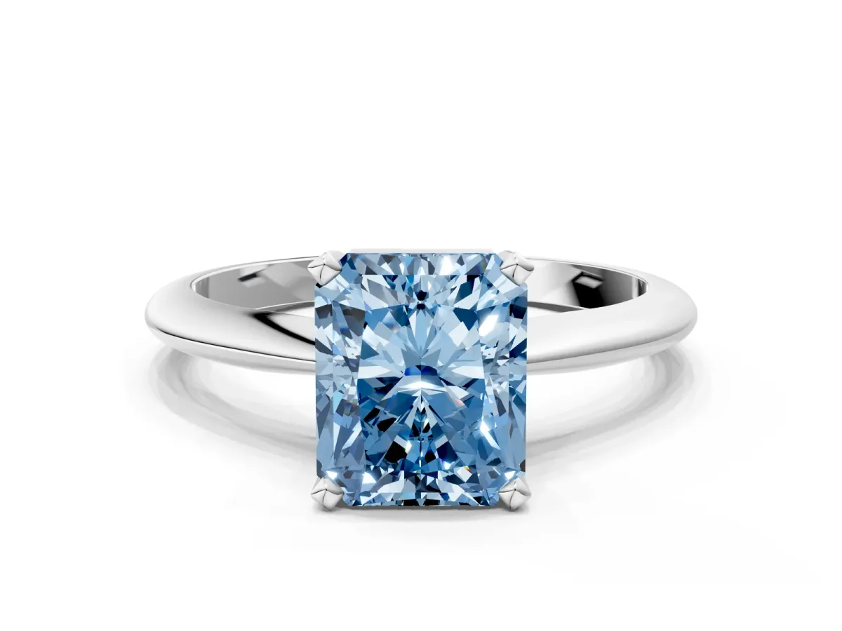 Fancy Blue Radiant Cut Cut Solitaire Ring with Four-Prong Setting on a Classic Band Platinum