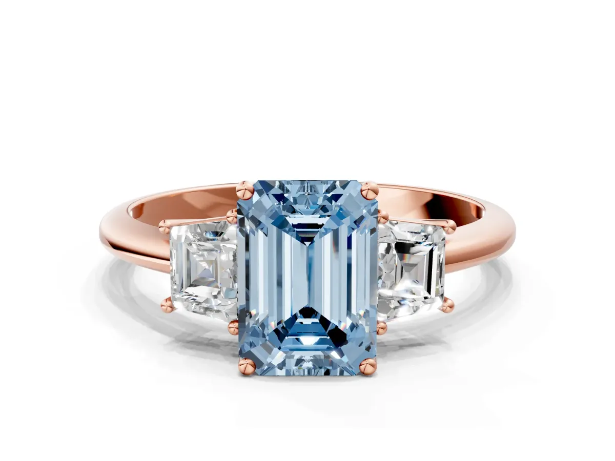 Fancy Blue Emerald Cut Diamond Three-Stone Ring with Trapezoid Side Stones and Prong Setting Rose gold