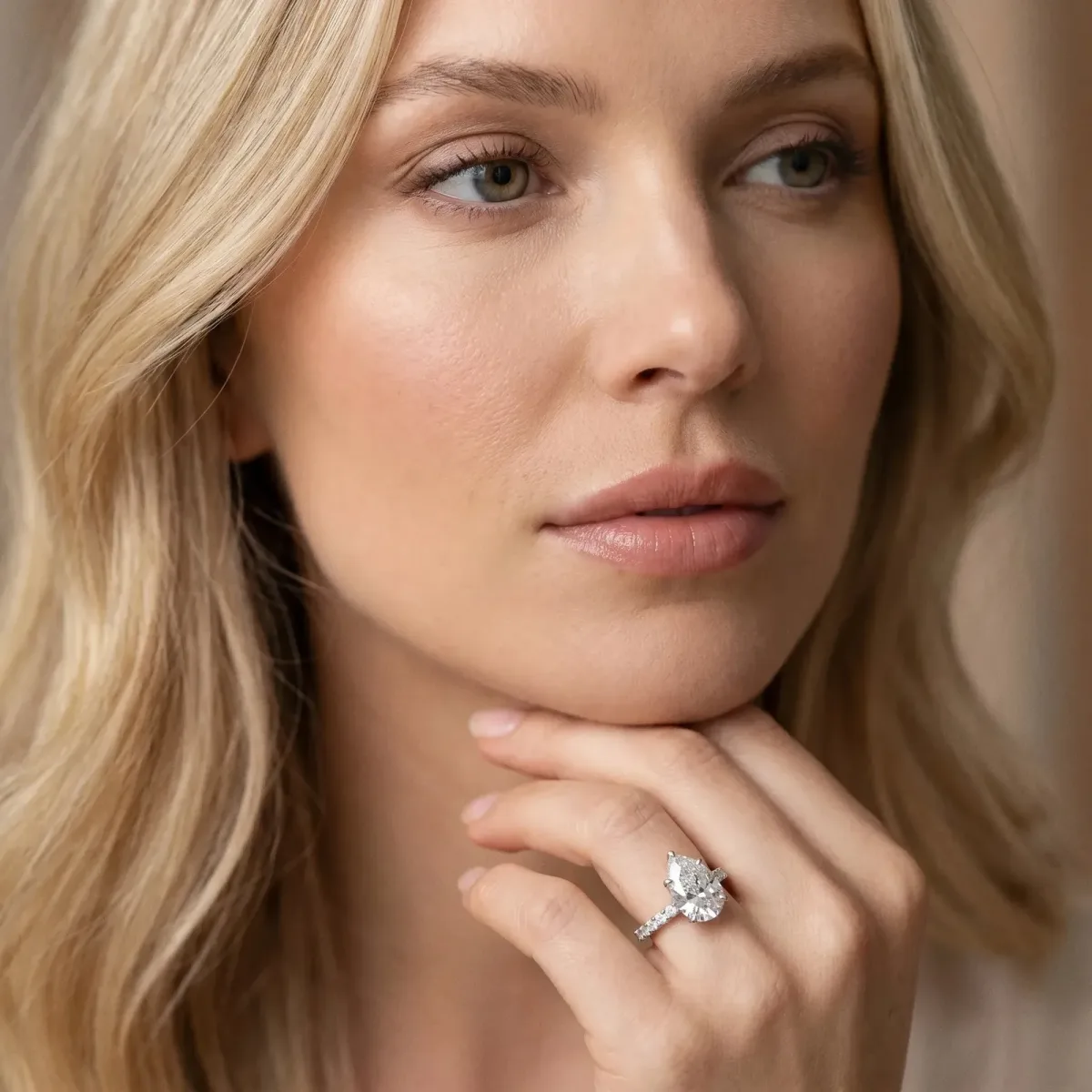 Pear Cut Diamond Solitaire Engagement Ring with Pavé Band and Four-Prong Setting Silver