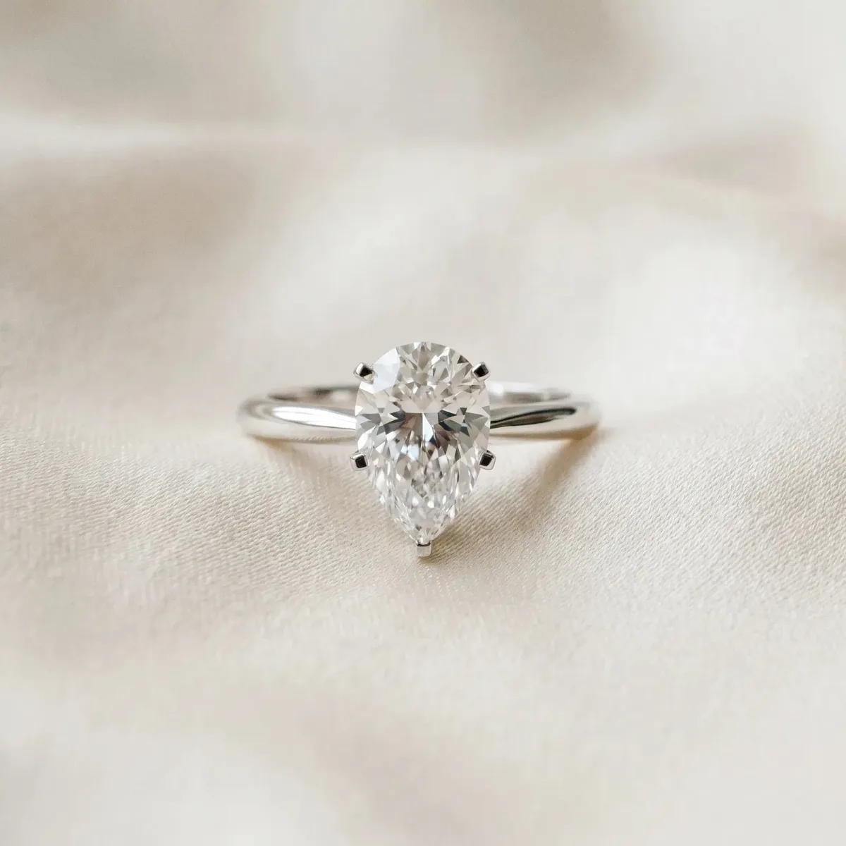 Pear Cut Diamond Solitaire Engagement Ring with Classic Band and Four-Prong Setting Silver