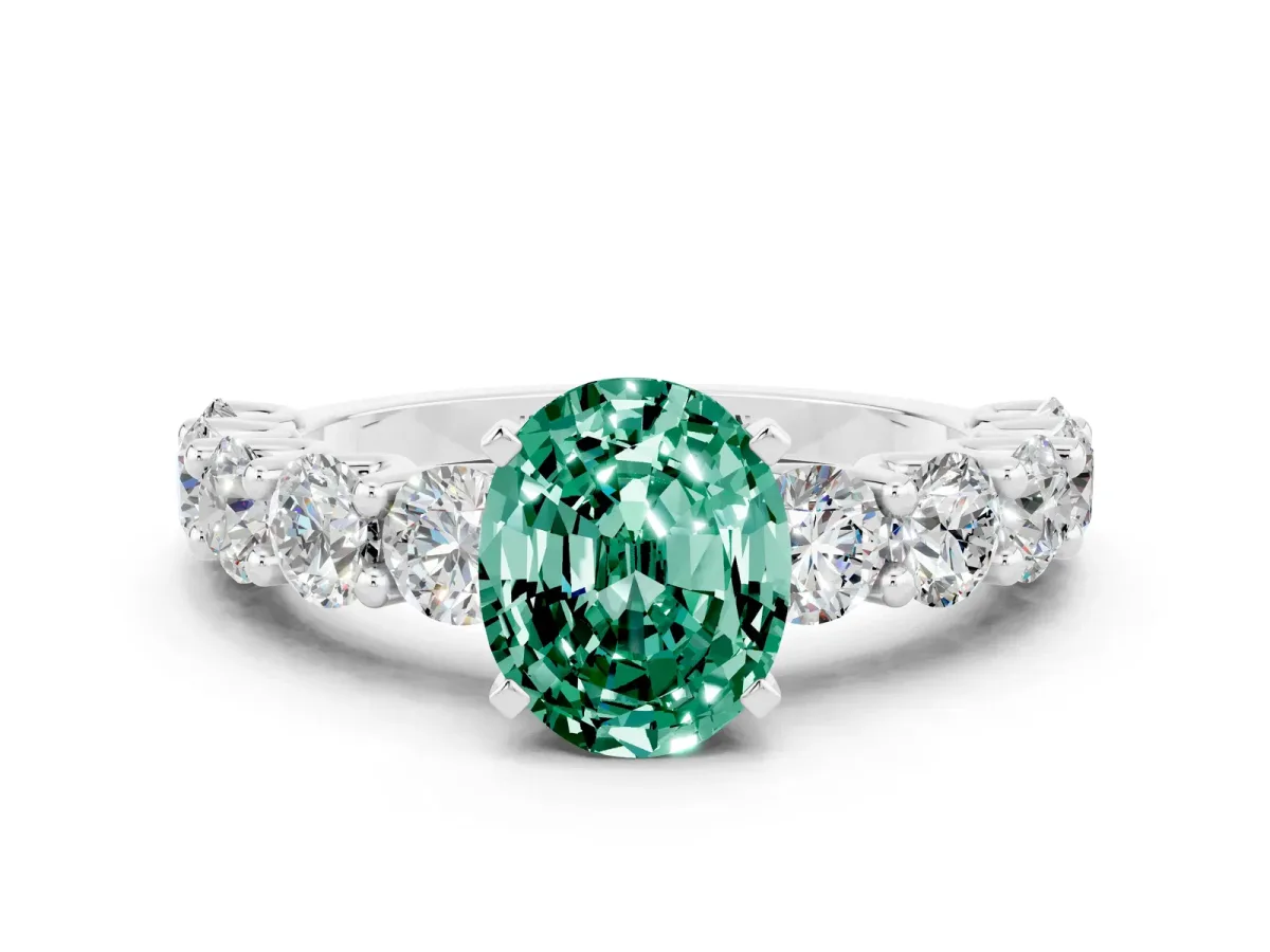 Oval Cut Green Sapphire Prong Setting with Side Stones on a Pave Band Silver