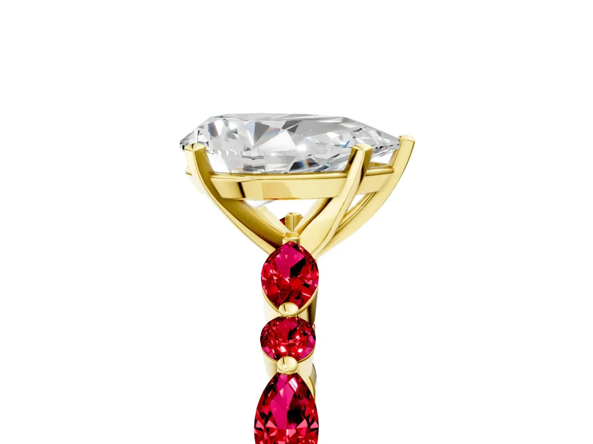 Pear Cut Diamond Ring with Marquise and Round Ruby Side Stones and Four-Prong Setting Yellow gold