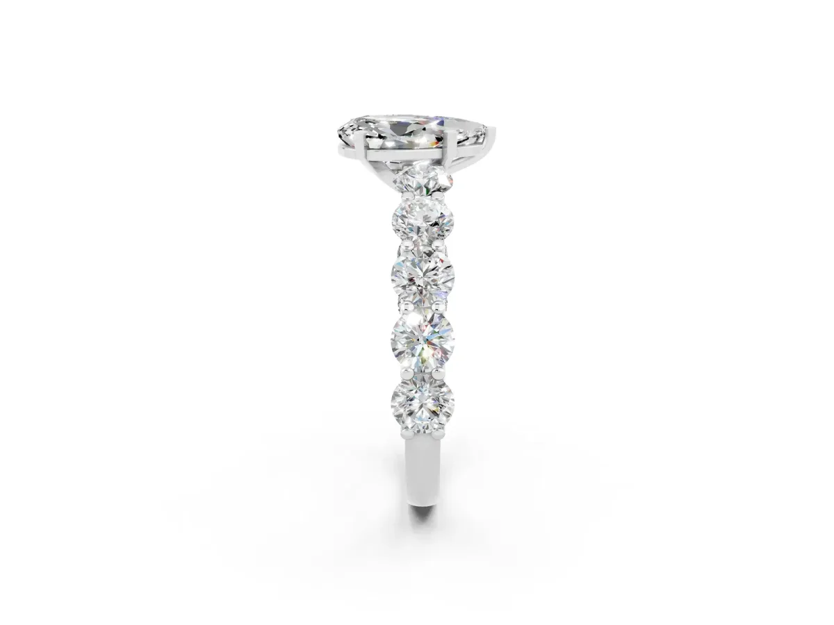 Pear Cut Moissanite Prong Setting with Side Stones on a Pave Band Silver