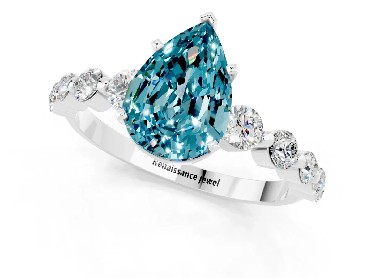 Pear Cut Solitaire Blue Topaz Ring with Pave Band and Four-Prong Setting Silver