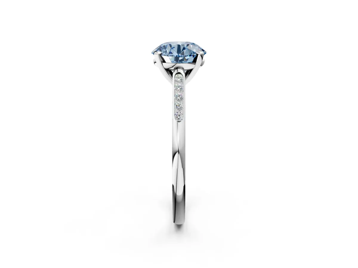 Fancy Blue Round Cut Diamond Solitaire Ring with Channel Set Round Band and Prong Setting Silver