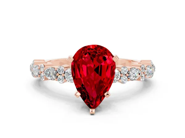 Pear Cut Ruby Side Stone Solitaire Ring with Round and Four-Prong Setting Rose gold