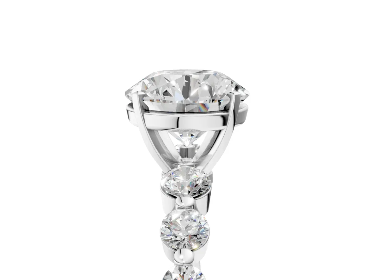 Round Cut Solitaire Diamond Ring with Pave Band and Four-Prong Setting Silver