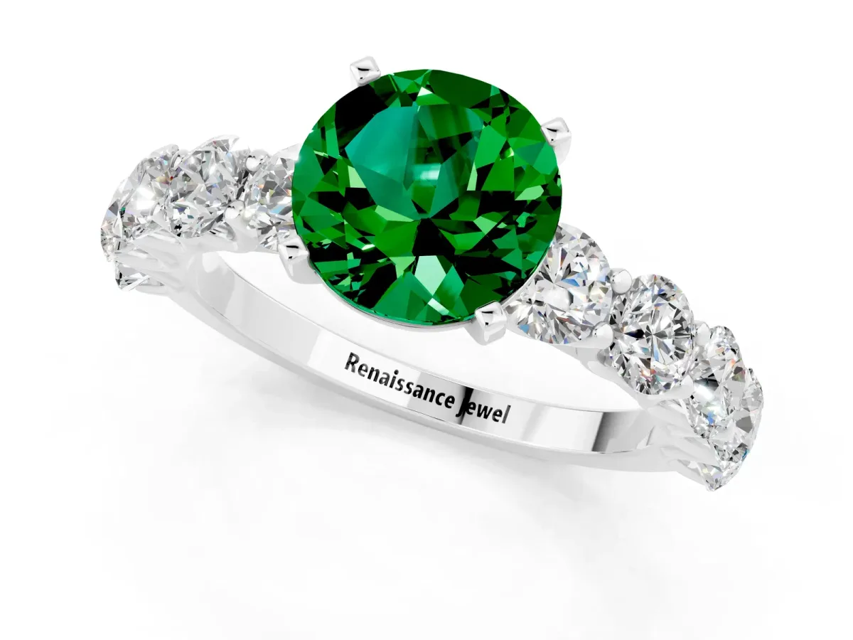 Round Cut Emerald Prong Setting with Side Stones on a Pave Band Silver