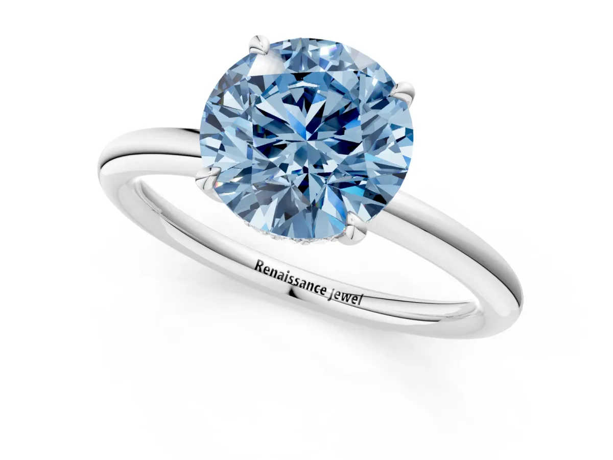 Fancy Blue Round Cut Diamond Solitaire Ring with Thin Band and Four-Prong Setting Silver