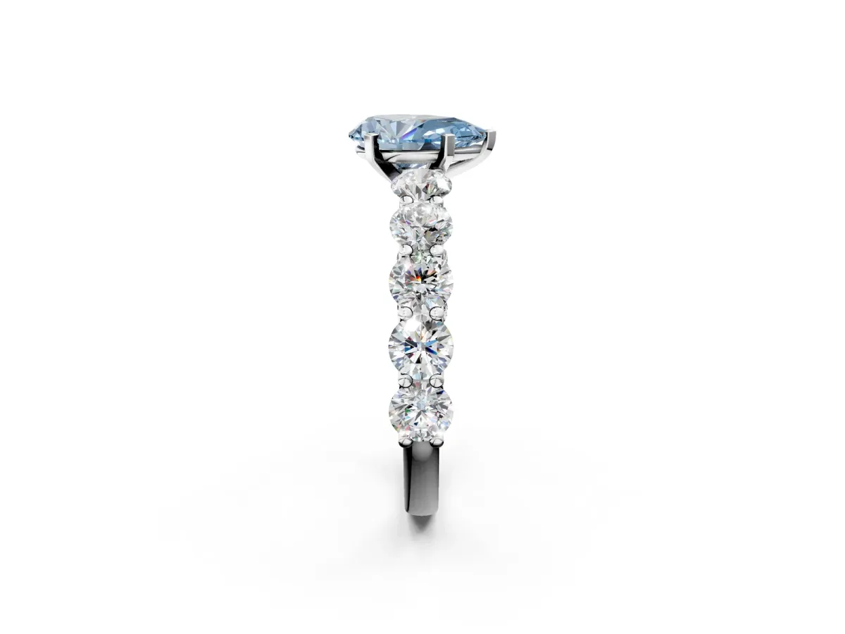 Fancy Blue Pear Cut Diamond Prong Setting with Side Stones on a Pave Band Platinum