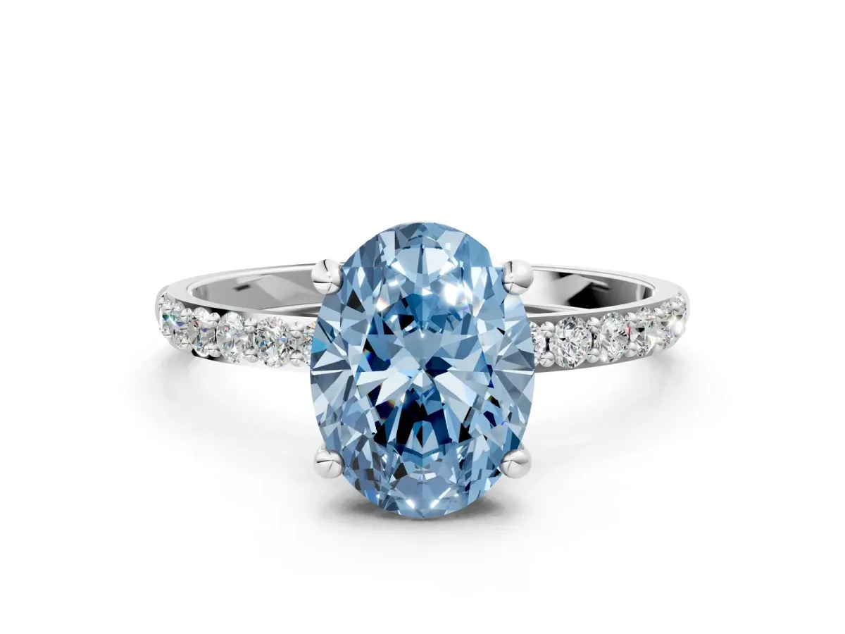 Fancy Blue Oval Cut Diamond Solitaire Ring with Round Pavé Band and Prong Setting Silver