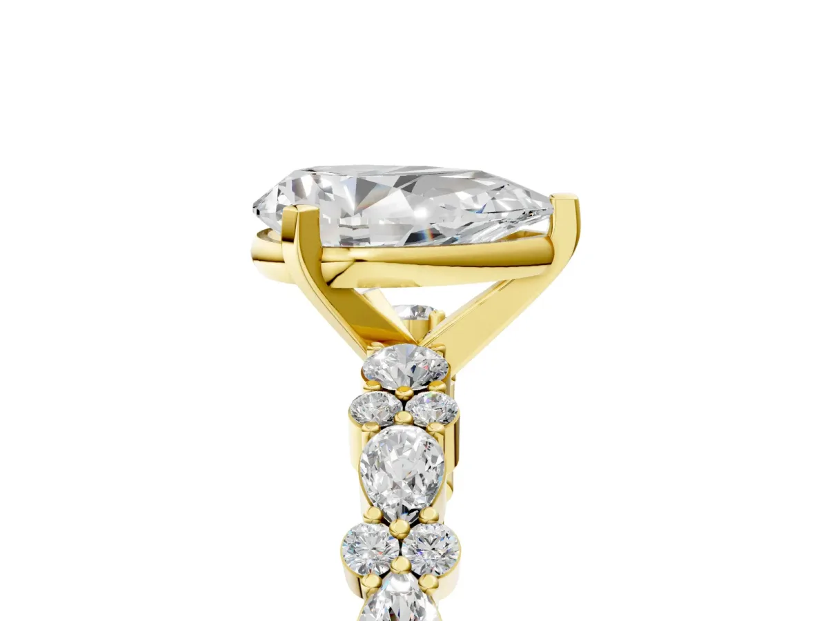 Pear Cut Diamond Side Stone Solitaire Ring with Round and Four-Prong Setting Yellow gold