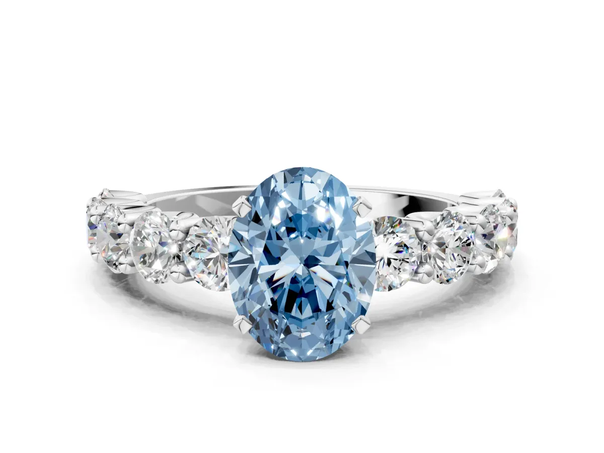 Fancy Blue Oval Cut Diamond Prong Setting with Side Stones on a Pave Band Platinum