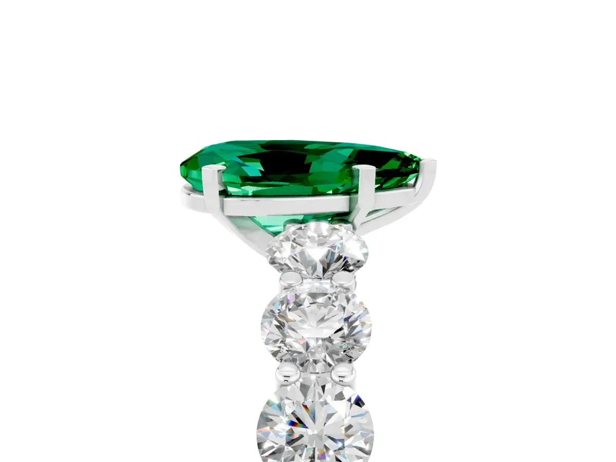 Pear Cut Emerald Prong Setting with Side Stones on a Pave Band Silver