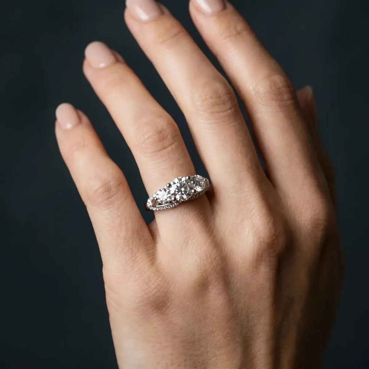 Round Cut Diamond Three-Stone Ring with Prong Setting and Pavé Band Platinum