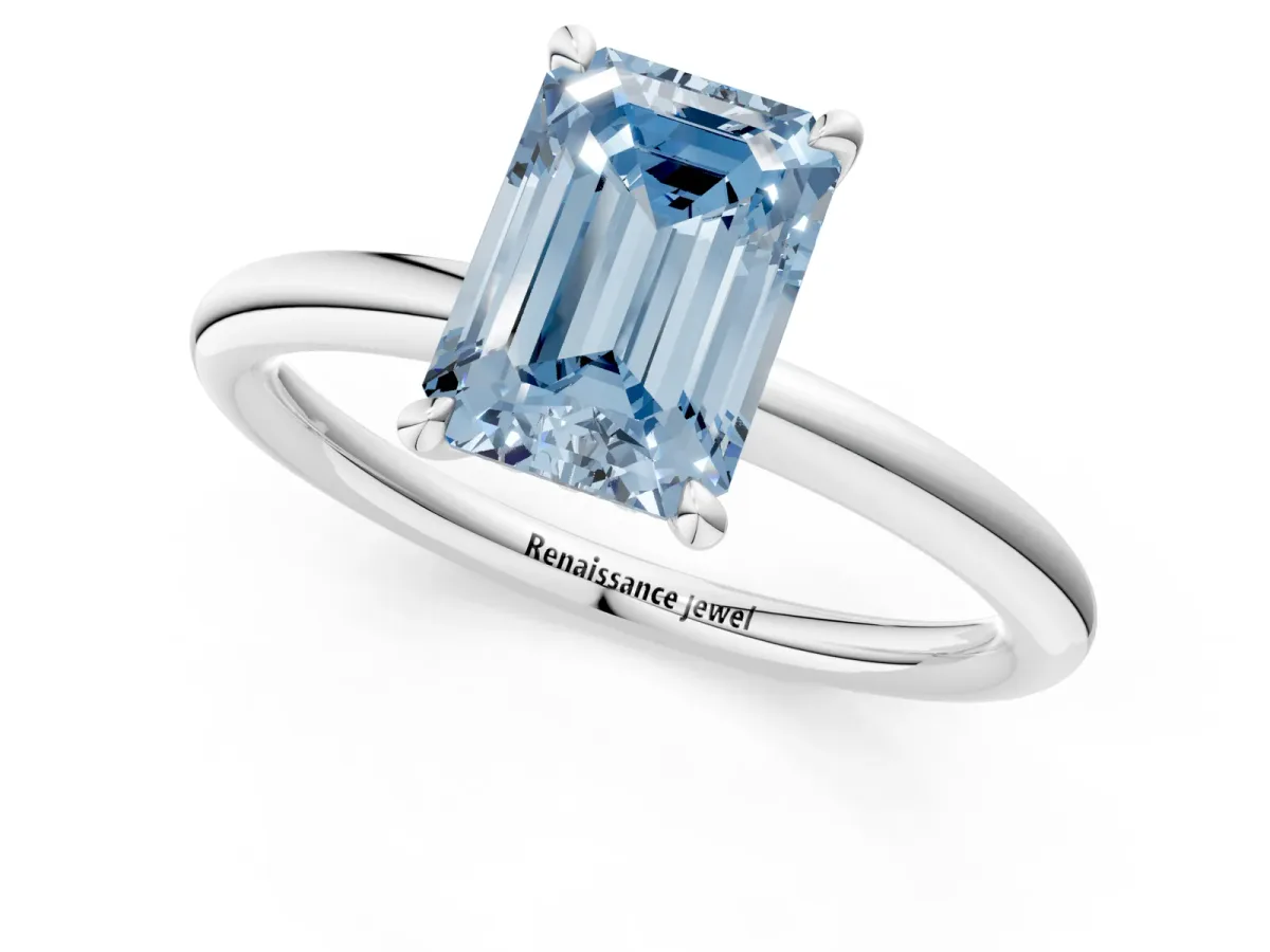 Fancy Blue Emerald Cut Diamond Solitaire Ring with Thin Band and Four-Prong Setting Platinum