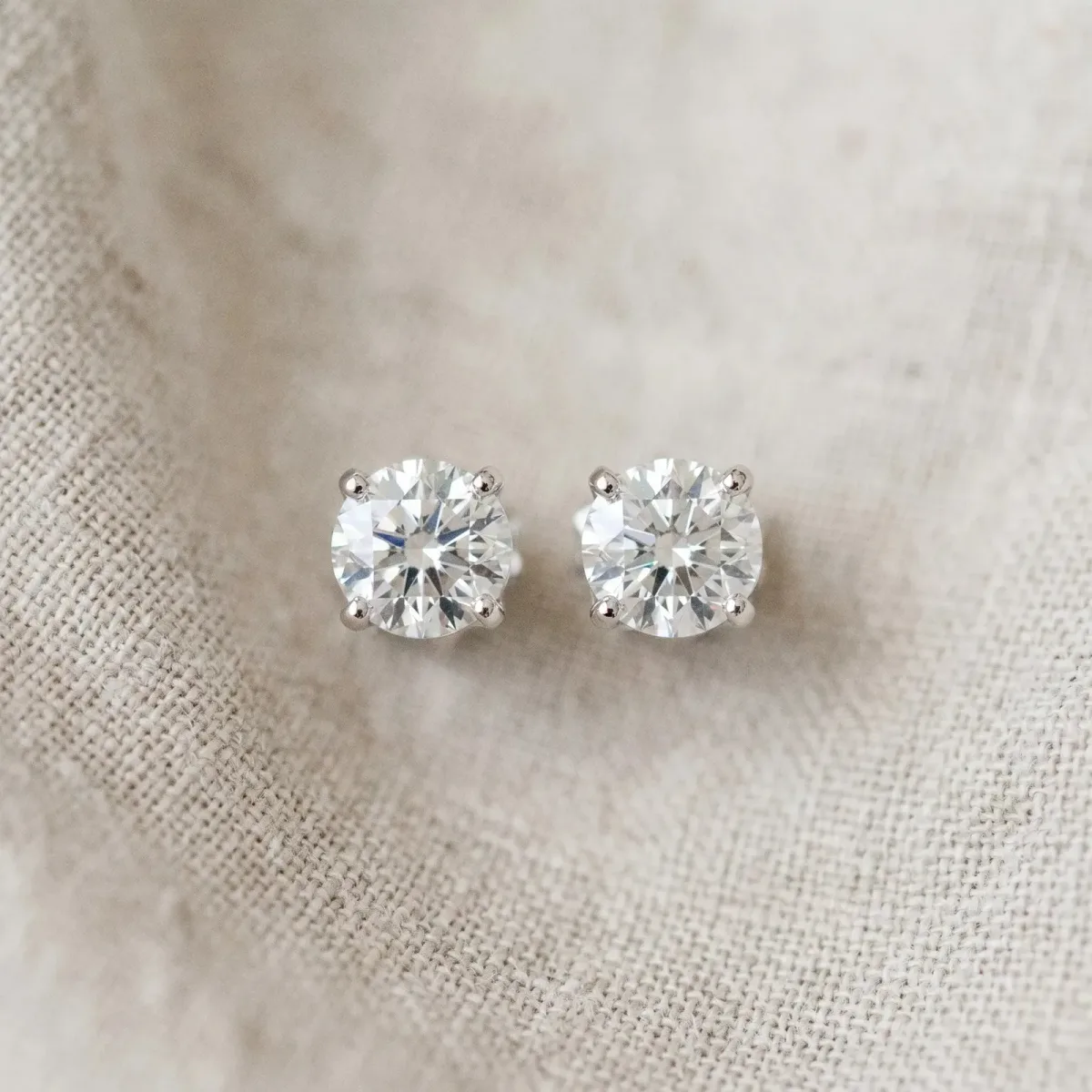 Round Solitaire Diamond Stud Earrings with Four-Prong Basket Setting Silver