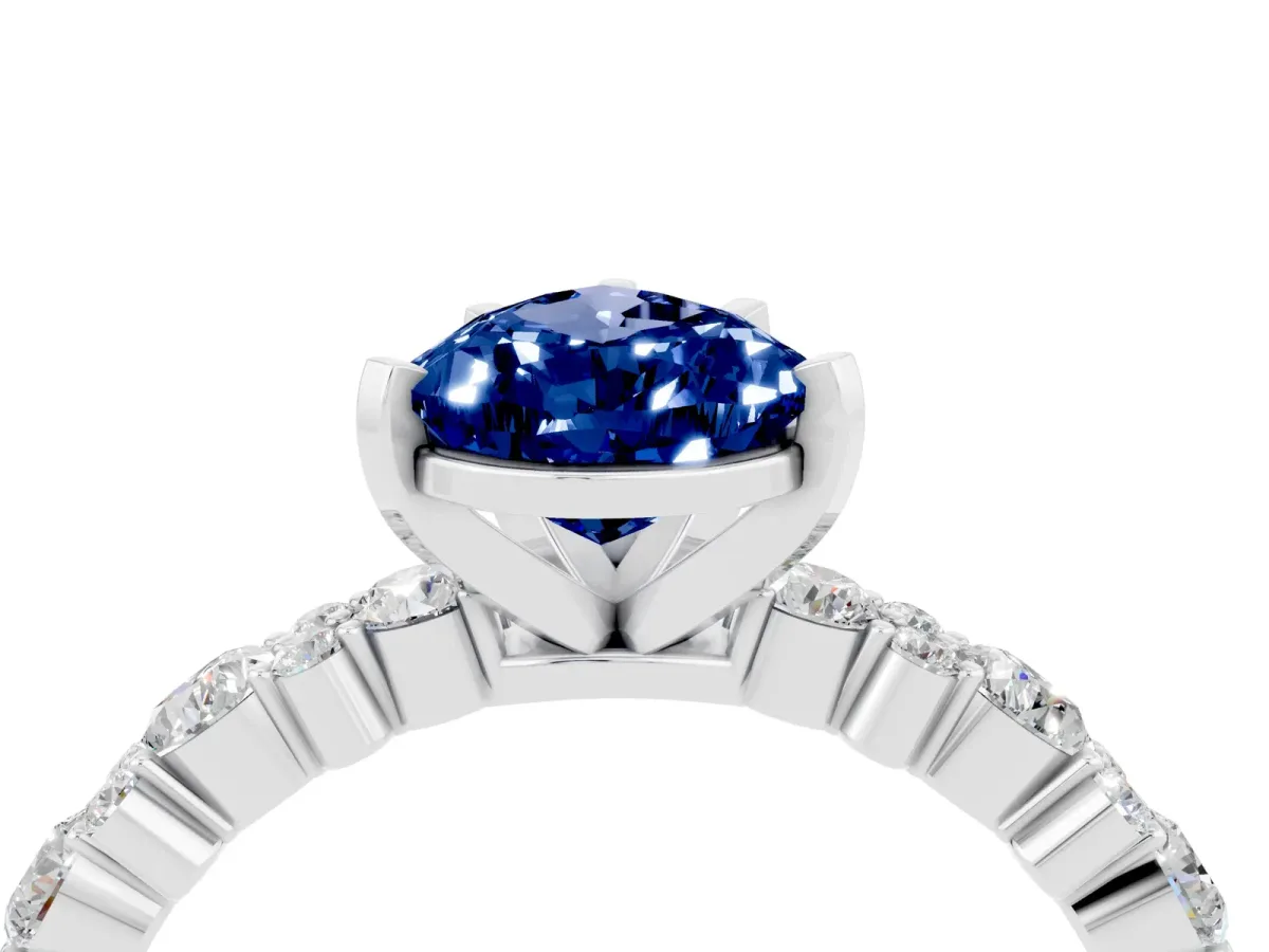 Pear Cut Blue Sapphire Side Stone Solitaire Ring with Round and Four-Prong Setting Silver