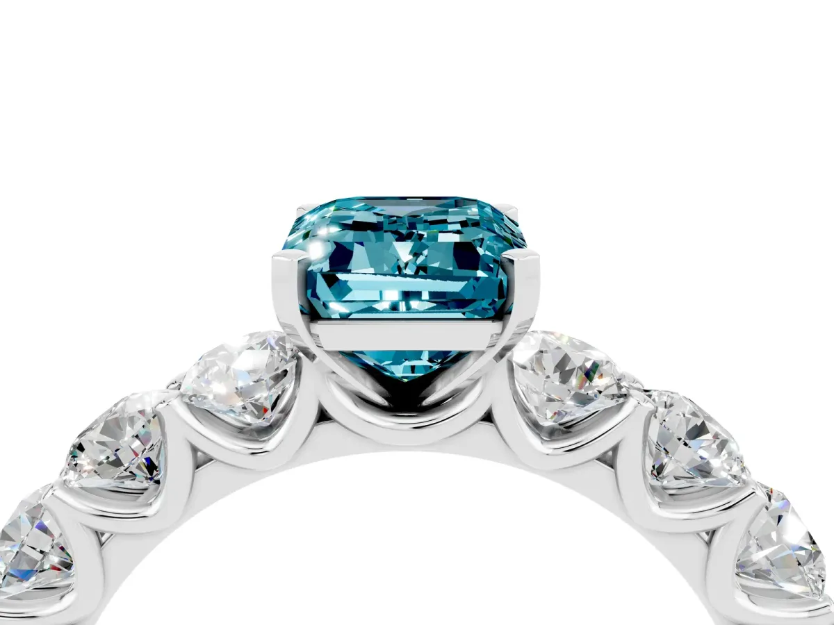 Emerald Cut Blue Topaz Prong Setting with Side Stones on a Pave Band Silver