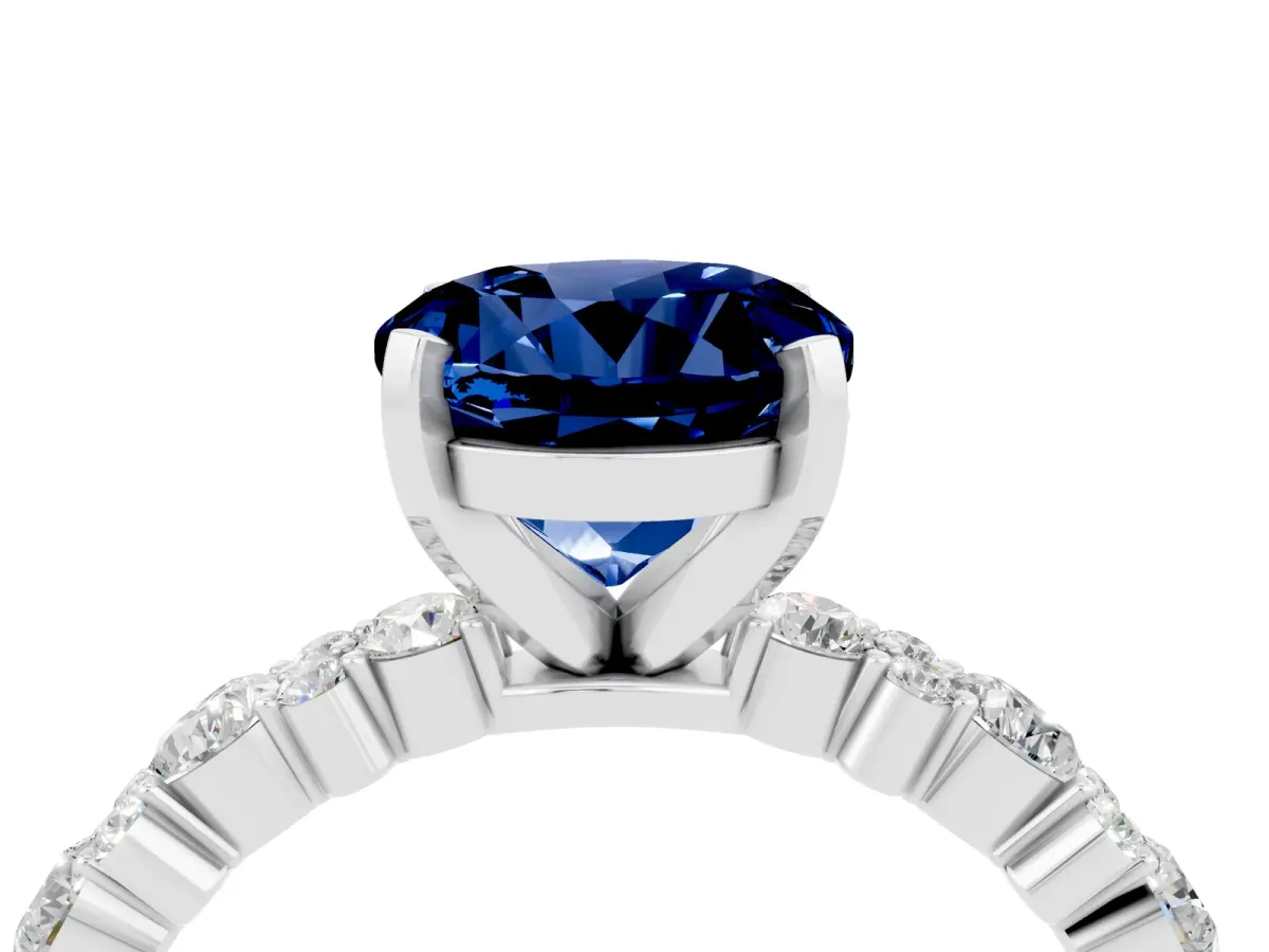 Round Cut Blue Sapphire Side Stone Solitaire Ring with Round and Four-Prong Setting Platinum