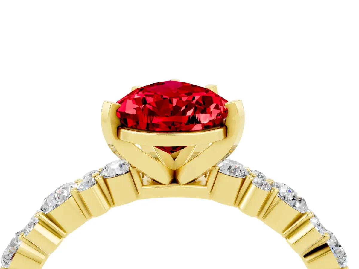Pear Cut Ruby Side Stone Solitaire Ring with Round and Four-Prong Setting Yellow gold
