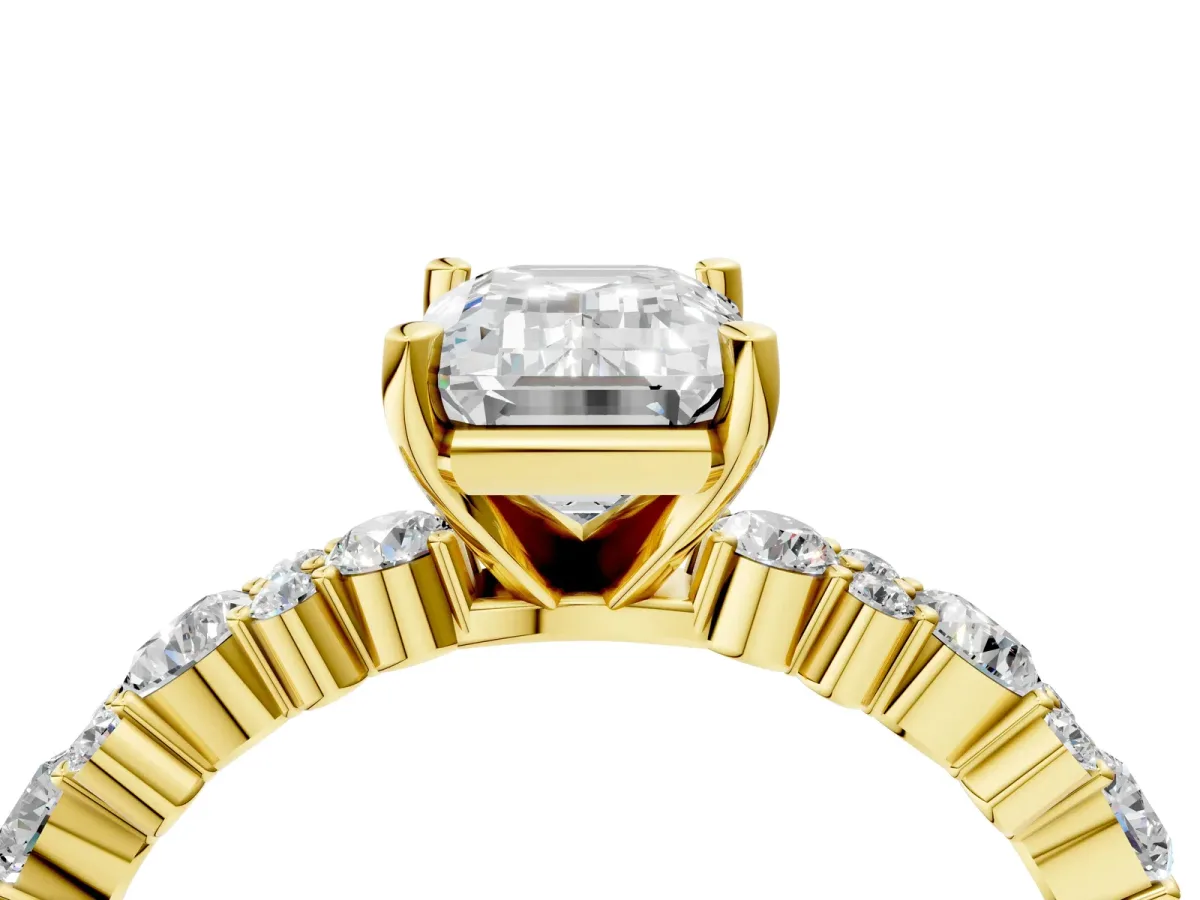 Emerald Cut Diamond Side Stone Solitaire Ring with Round and Four-Prong Setting Yellow gold