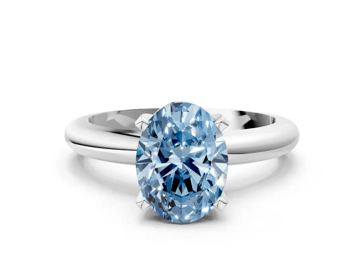 Fancy Blue Oval Cut Diamond Solitaire Engagement Ring with Round Band and Four-Prong Setting Silver