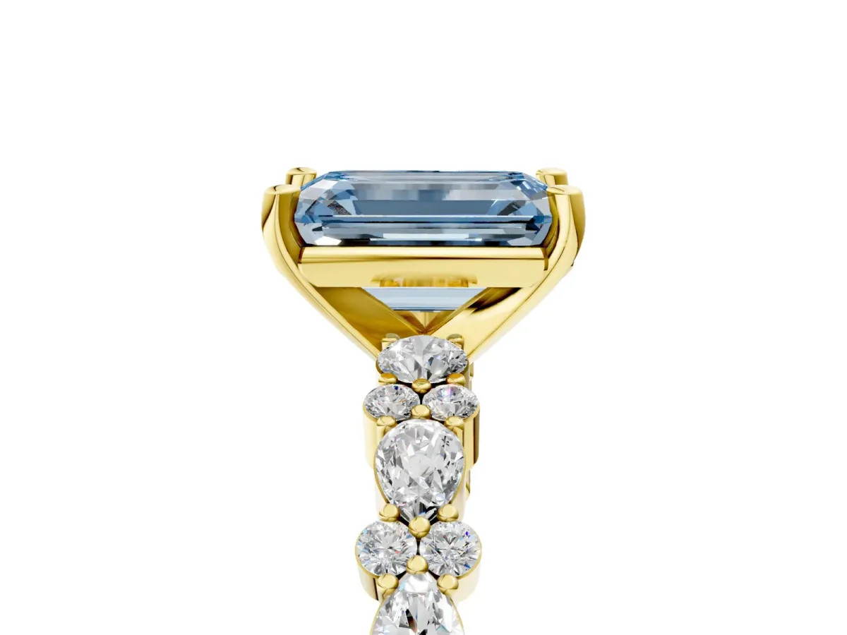 Fancy Blue Emerald Cut Diamond Side Stone Solitaire Ring with Round and Four-Prong Setting Yellow gold