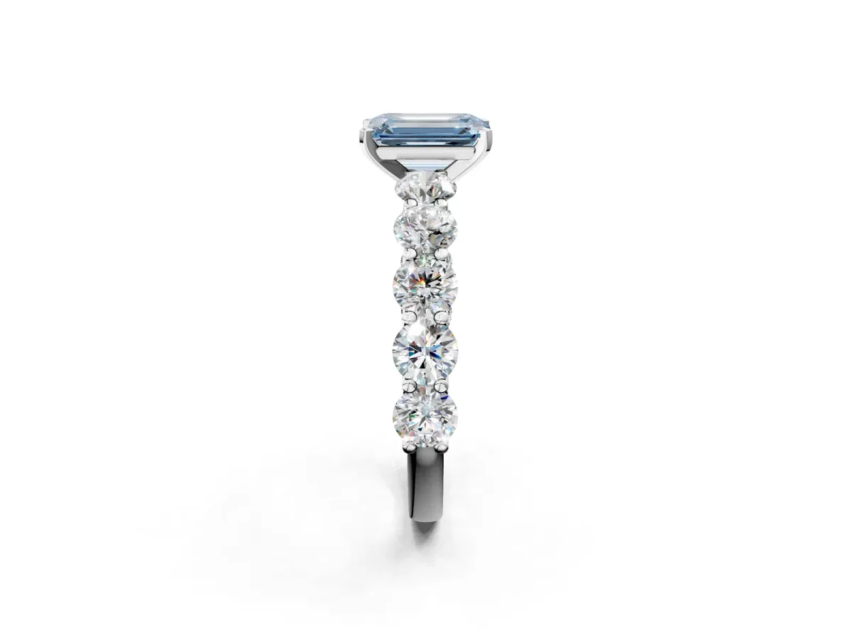 Fancy Blue Emerald Cut Diamond Prong Setting with Side Stones on a Pave Band Silver