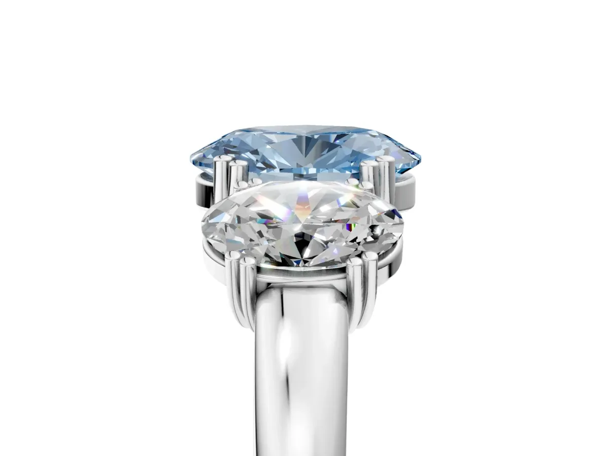 Fancy Blue Three-Stone Oval Cut Cut Diamond Ring with Channel Set Band and Four-Prong Setting Silver