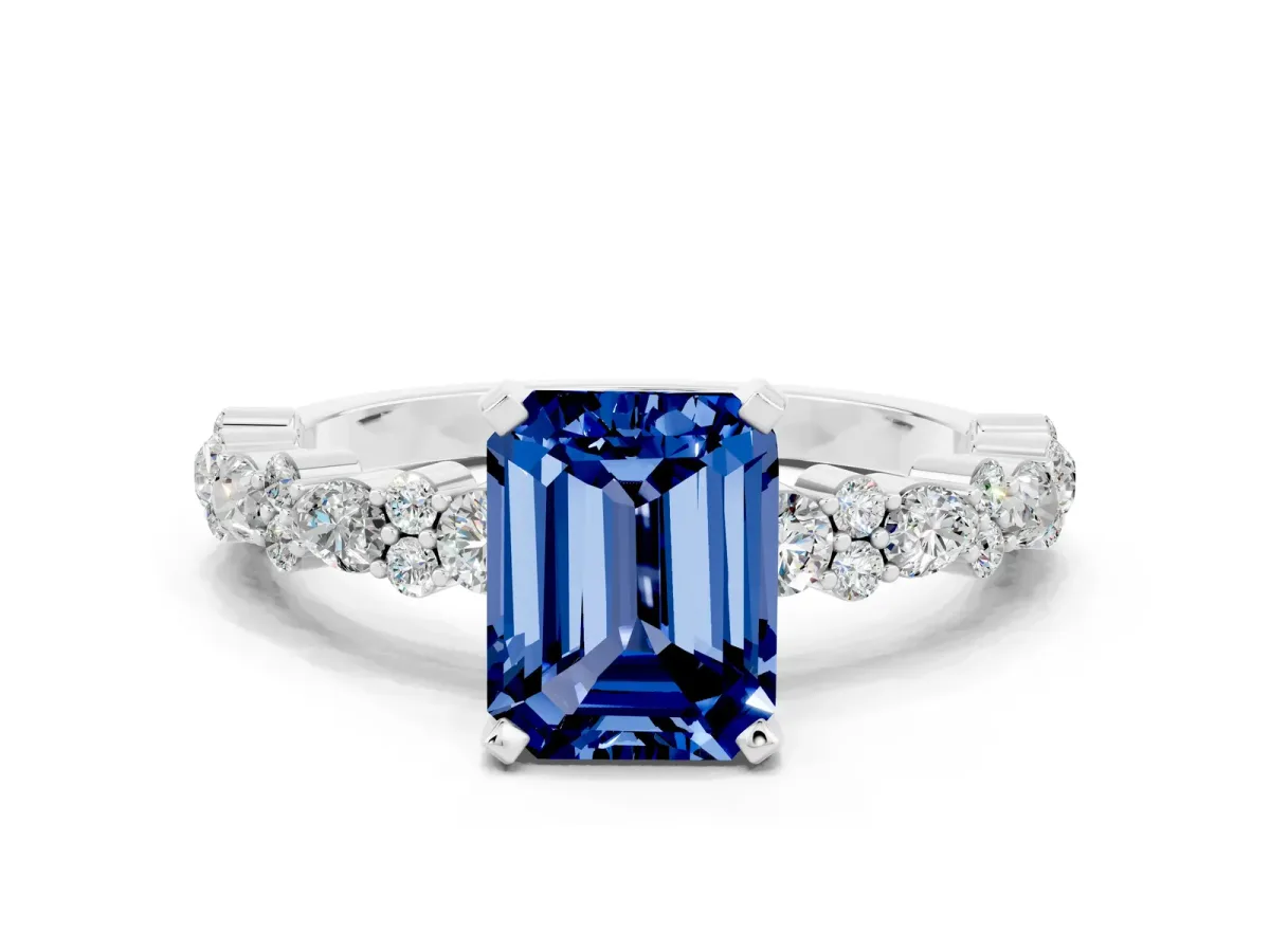 Emerald Cut Blue Sapphire Side Stone Solitaire Ring with Round and Four-Prong Setting Silver