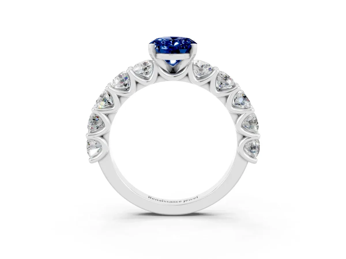 Oval Cut Blue Sapphire Prong Setting with Side Stones on a Pave Band Silver