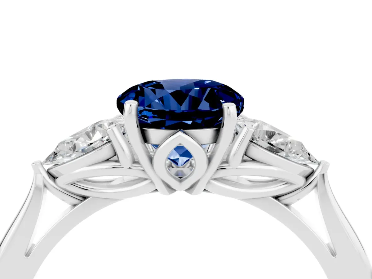 Three-Stone Round Cut Blue Sapphire Ring with Pear Side Stones in Four-Prong Setting Platinum