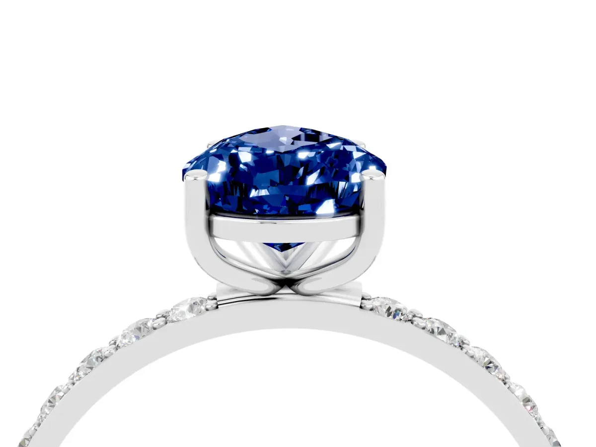 Pear Cut Blue Sapphire Solitaire Ring with Round Pavé Band and Prong Setting Silver