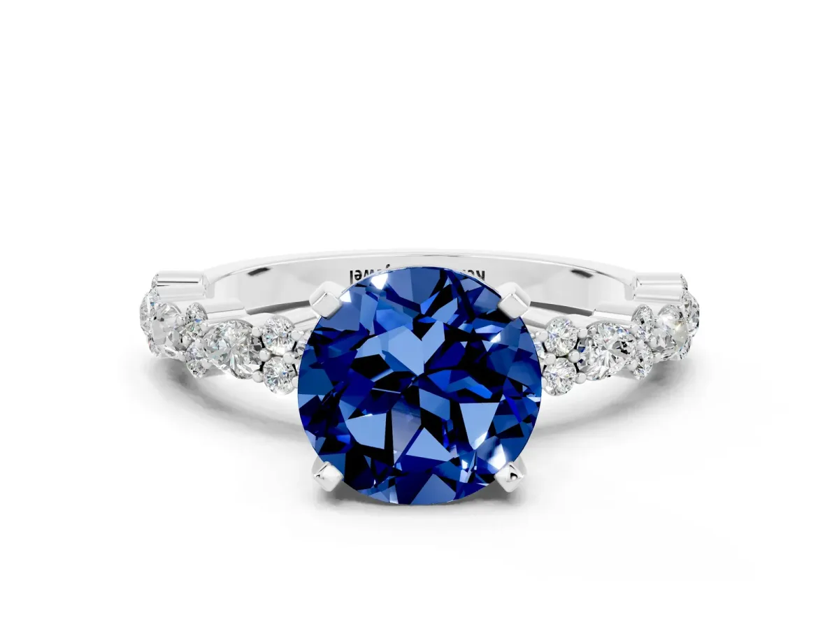 Round Cut Blue Sapphire Side Stone Solitaire Ring with Round and Four-Prong Setting Platinum