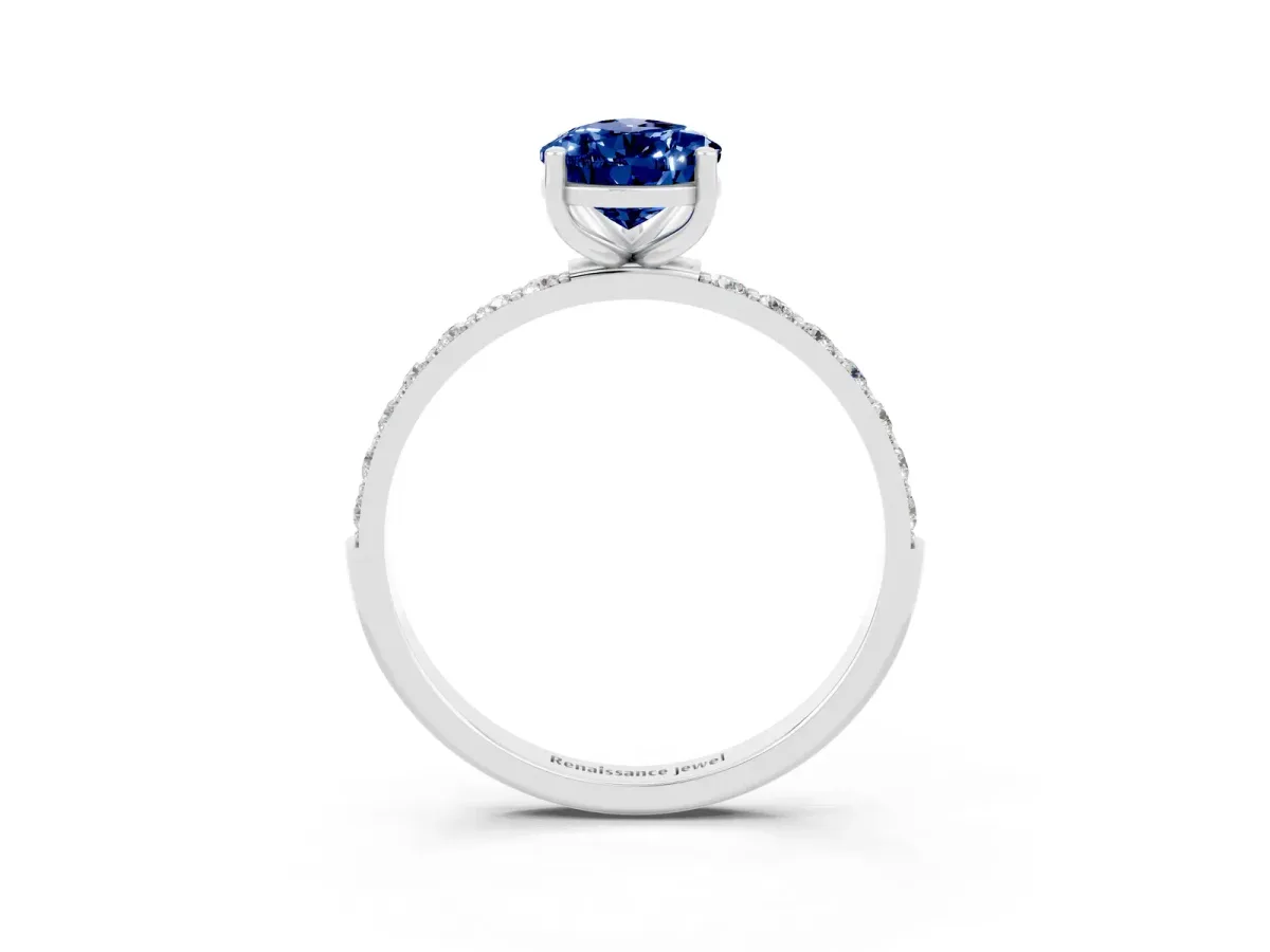 Pear Cut Blue Sapphire Solitaire Ring with Round Pavé Band and Prong Setting Silver