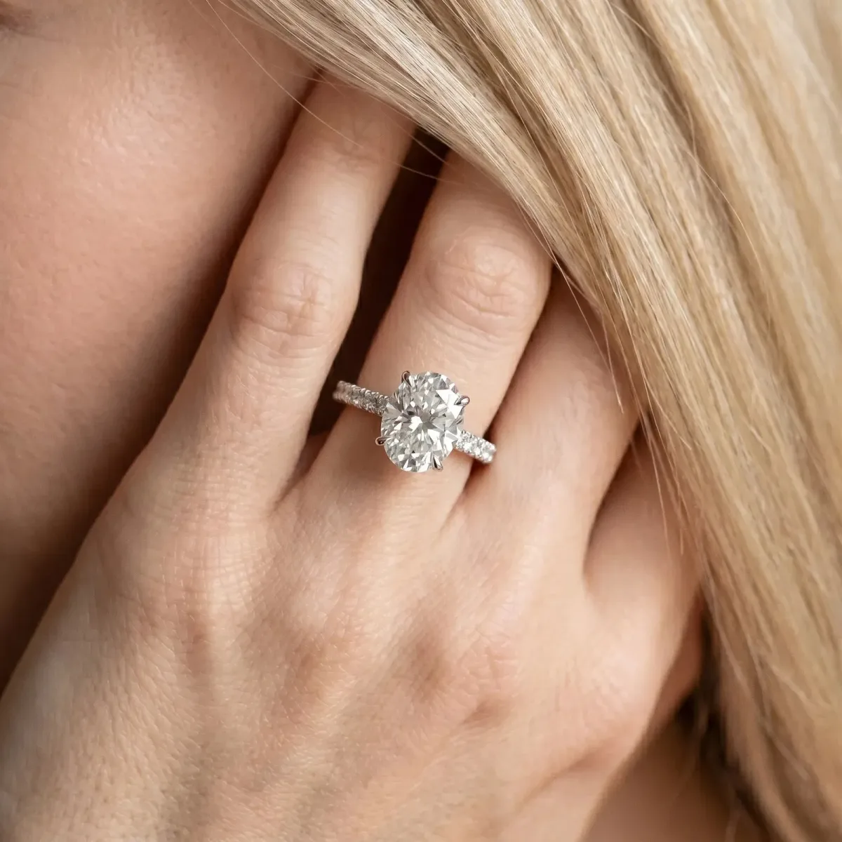 Oval Cut Diamond Solitaire Ring with Round Pavé Band and Four-Prong Setting Platinum