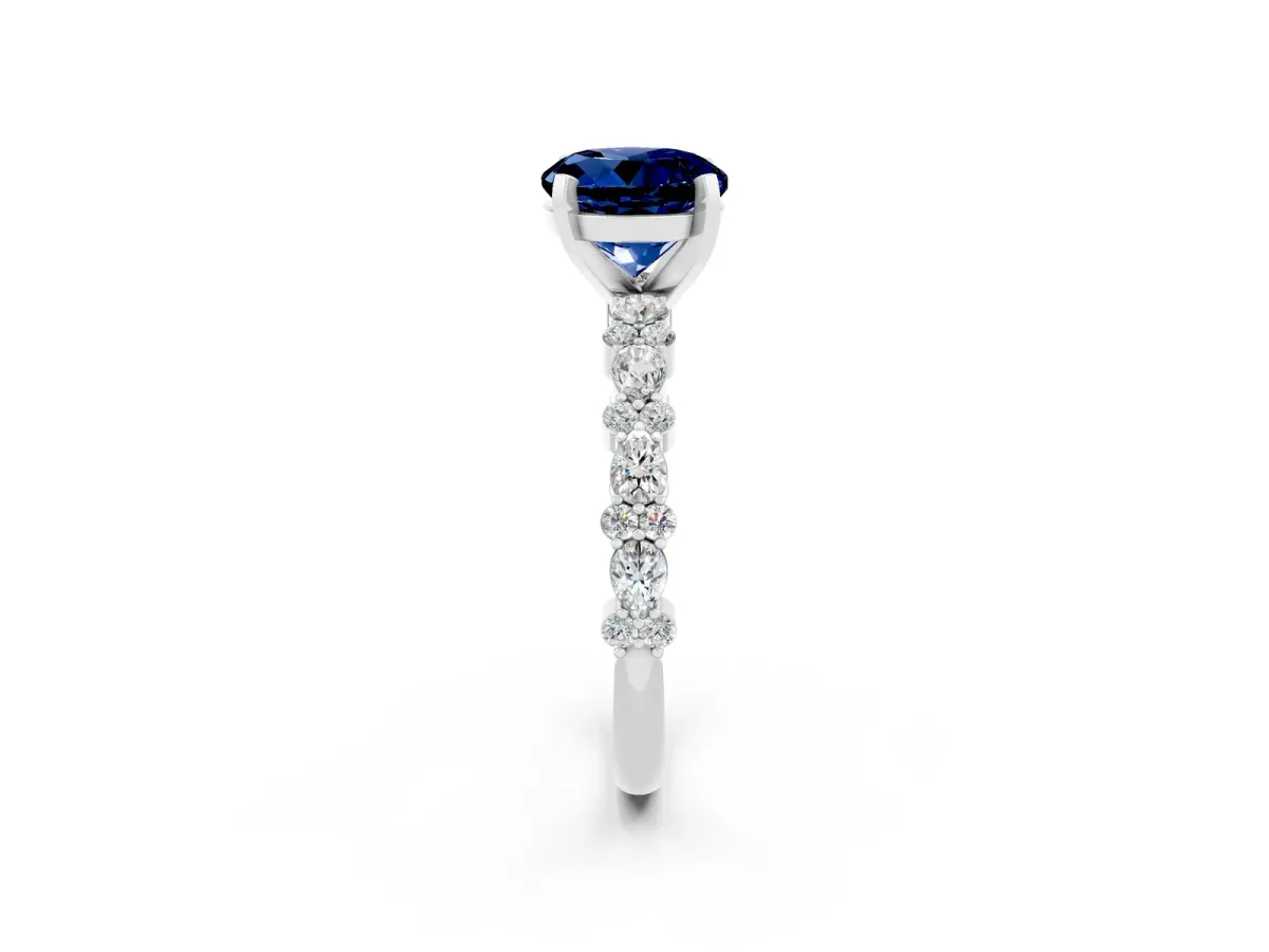Round Cut Blue Sapphire Side Stone Solitaire Ring with Round and Four-Prong Setting Platinum